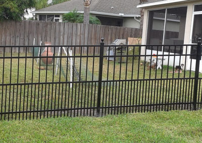 aluminum fence at the back of a residential property