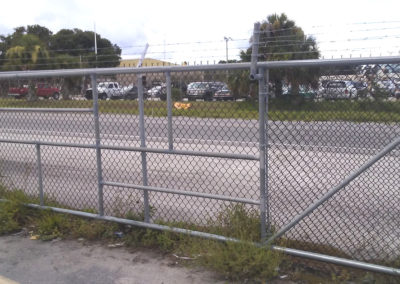 A chain link fence on the side of a road.