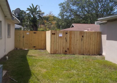 A small backyard with a wooden fence.